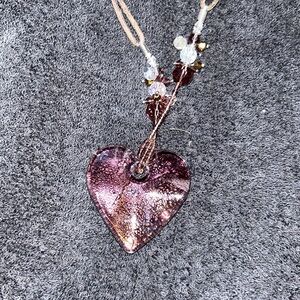 Roped necklace with a silver chain, clasp with clear heart pendant